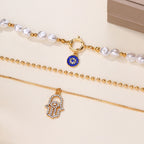 Jade – Mehrschichtiges Collier mit Perlen und Hamsa